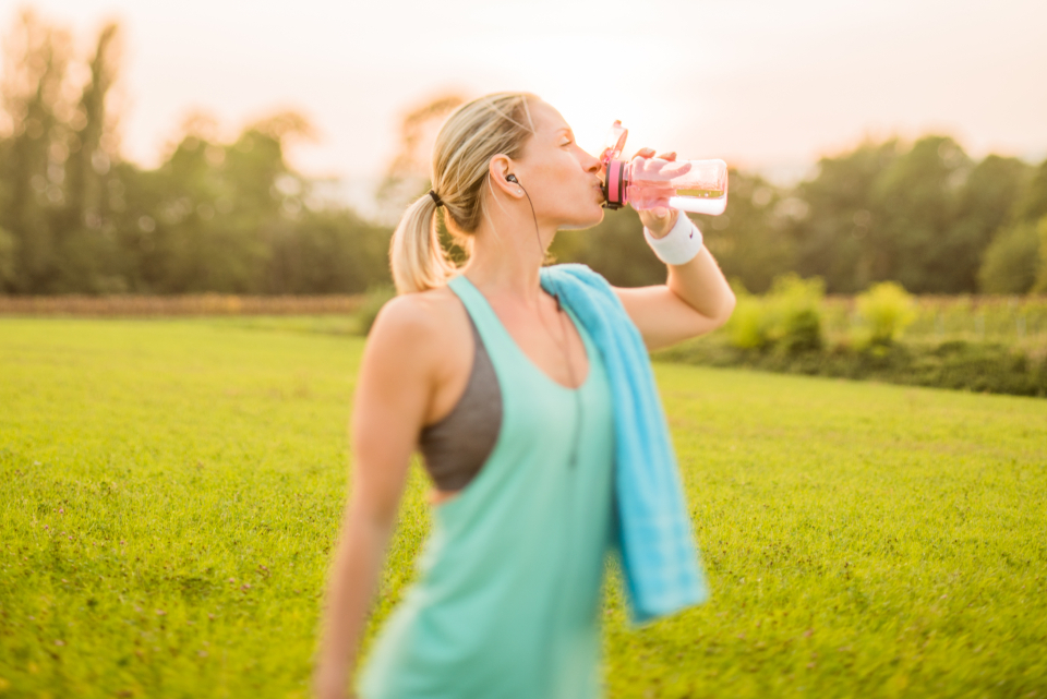 Athlete drinking water outdoors