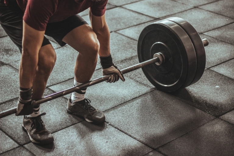 Lifter setting up a heavy barbell deadlift in the gym