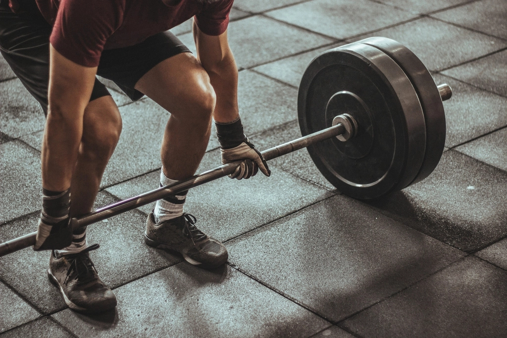 Lifter setting up a heavy barbell deadlift in the gym