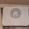 Bathroom scale on a tiled floor