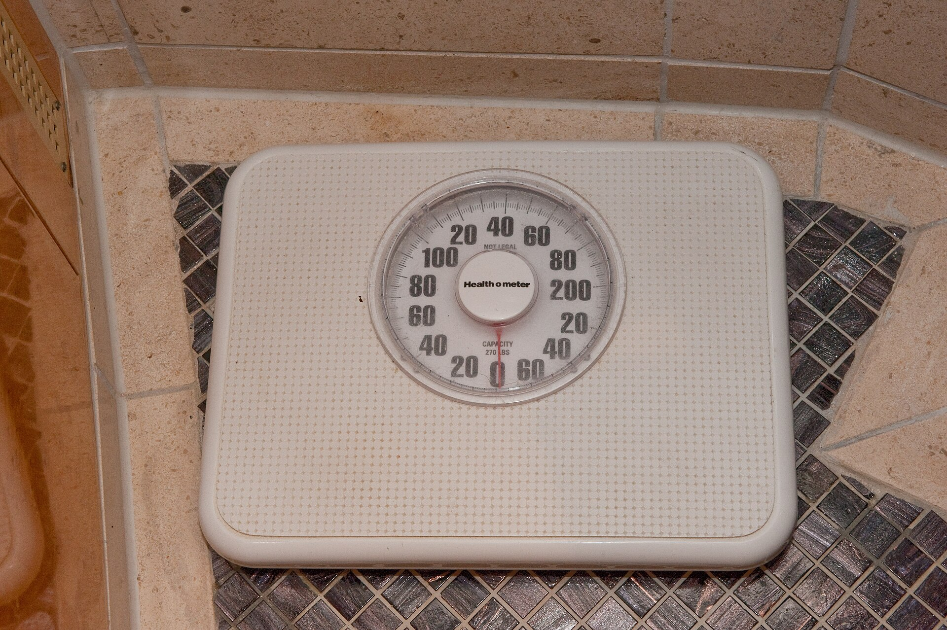 Bathroom scale on a tiled floor