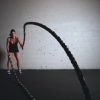 Athlete training with battle ropes