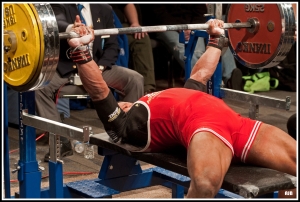 Powerlifter bench pressing at a competition