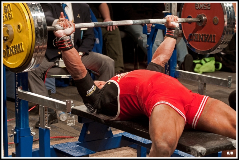 Powerlifter bench pressing at a competition
