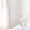 Bright, calm bedroom with a made bed