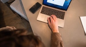 Hands typing on a laptop while shopping online