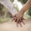 Couple holding hands on a walk
