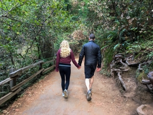Couple walking together on a forest trail