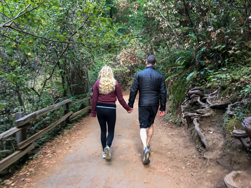 Couple walking together on a forest trail