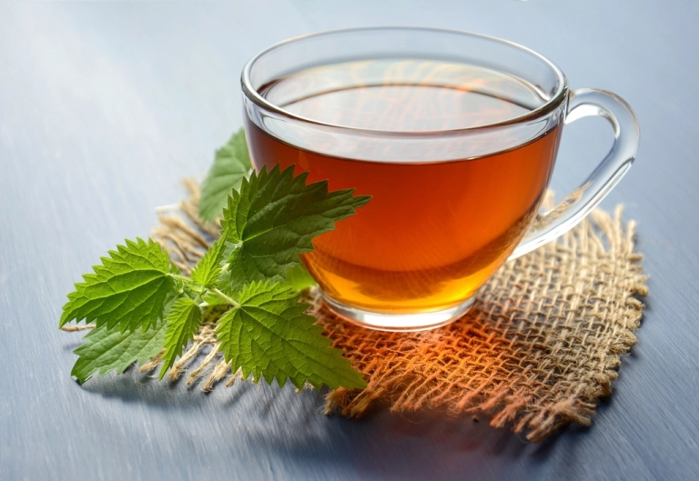 Cup of tea with fresh mint leaves