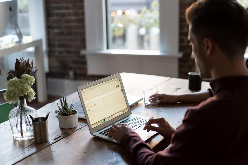 Man working at a desk with a laptop
