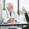 Doctor talking with a patient in his office