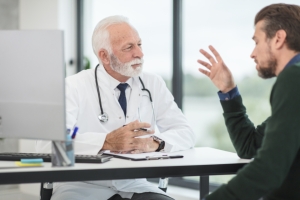 Doctor talking with a patient in his office