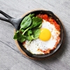 Eggs and spinach in a cast-iron skillet
