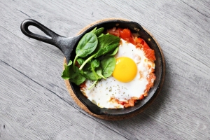 Eggs and spinach in a cast-iron skillet