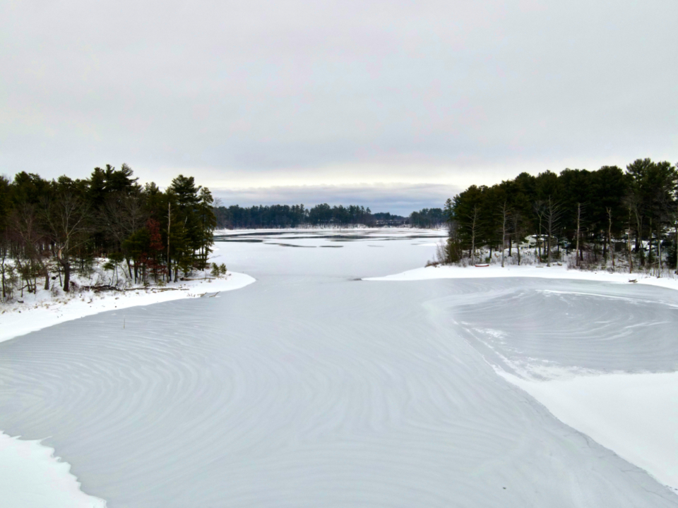 Frozen lake with snow-covered shoreline