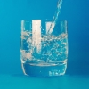 Glass of water on a blue background