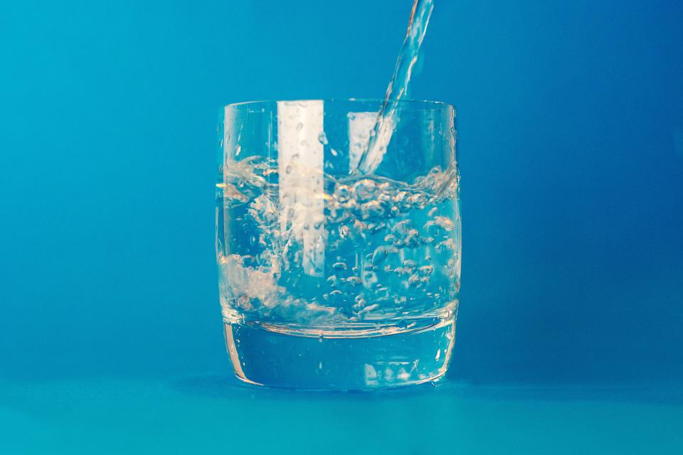 Glass of water on a blue background