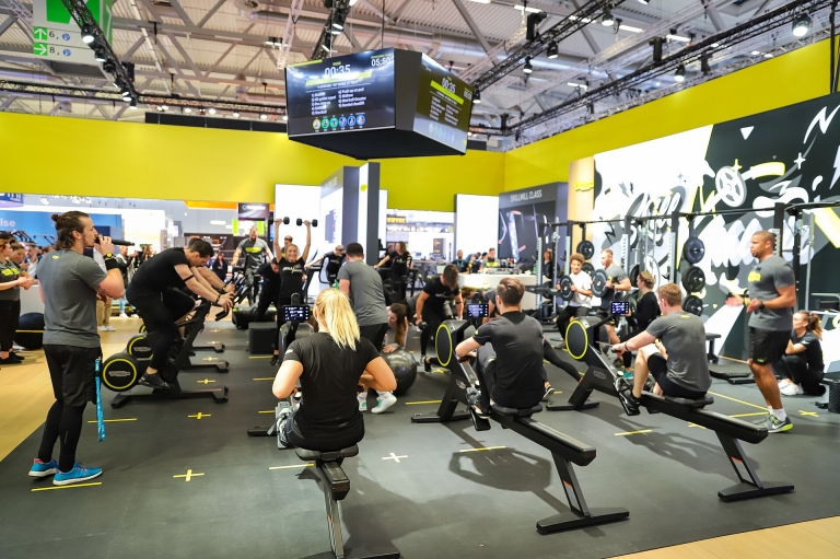 Group fitness class in a busy gym