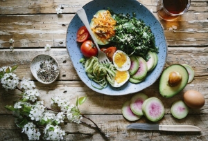 Healthy bowl with greens, egg and avocado
