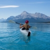 Kayaker paddling on a mountain lake
