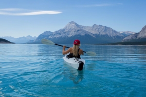 Kayaker paddling on a mountain lake