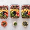Meal prep containers with grains, vegetables and protein