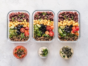 Meal prep containers with grains, vegetables and protein