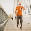 Man jogging across a bridge in the morning
