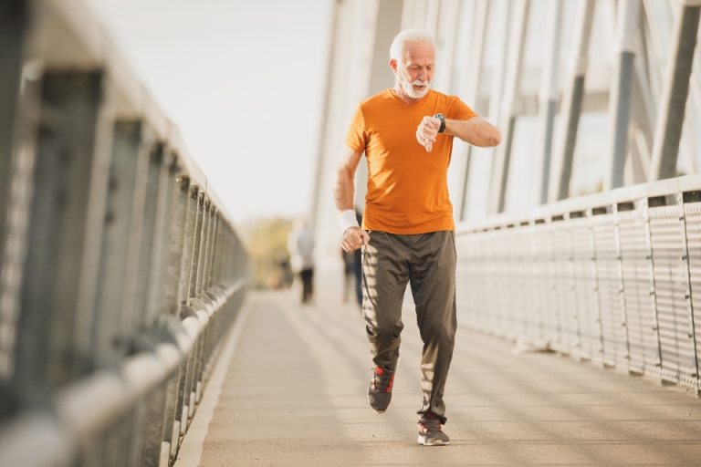 Man jogging across a bridge in the morning