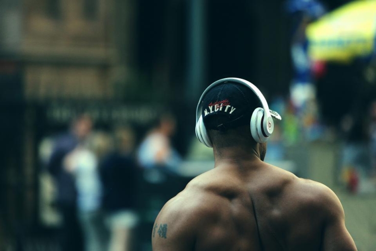 Muscular man with headphones in a gym
