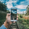 Hand holding a phone outdoors