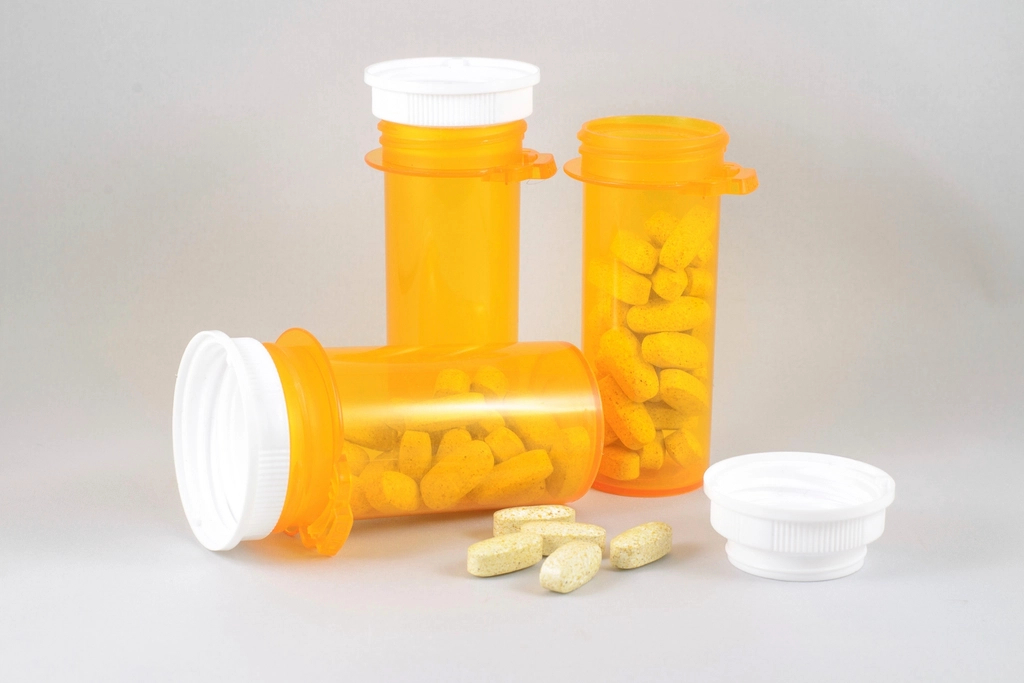 Pill bottles and tablets on a white table