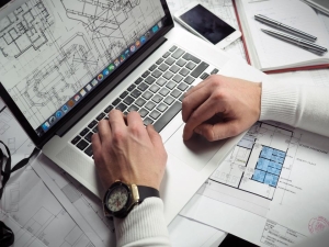 Person planning at a laptop with notes