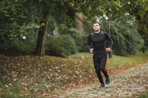 Man running on a path through a park