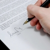 Hand signing a document