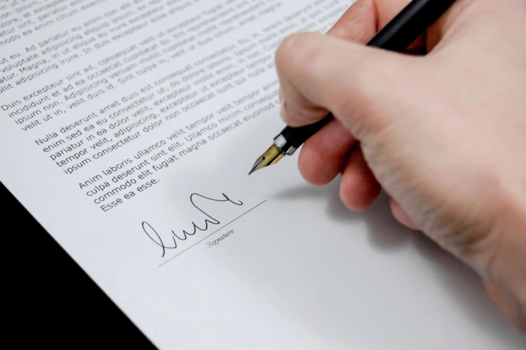 Hand signing a document