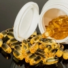 Supplement softgels spilling from a bottle