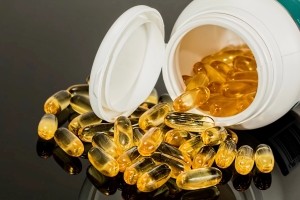 Supplement softgels spilling from a bottle