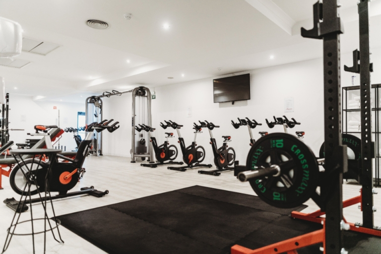 Gym with a squat rack and bikes