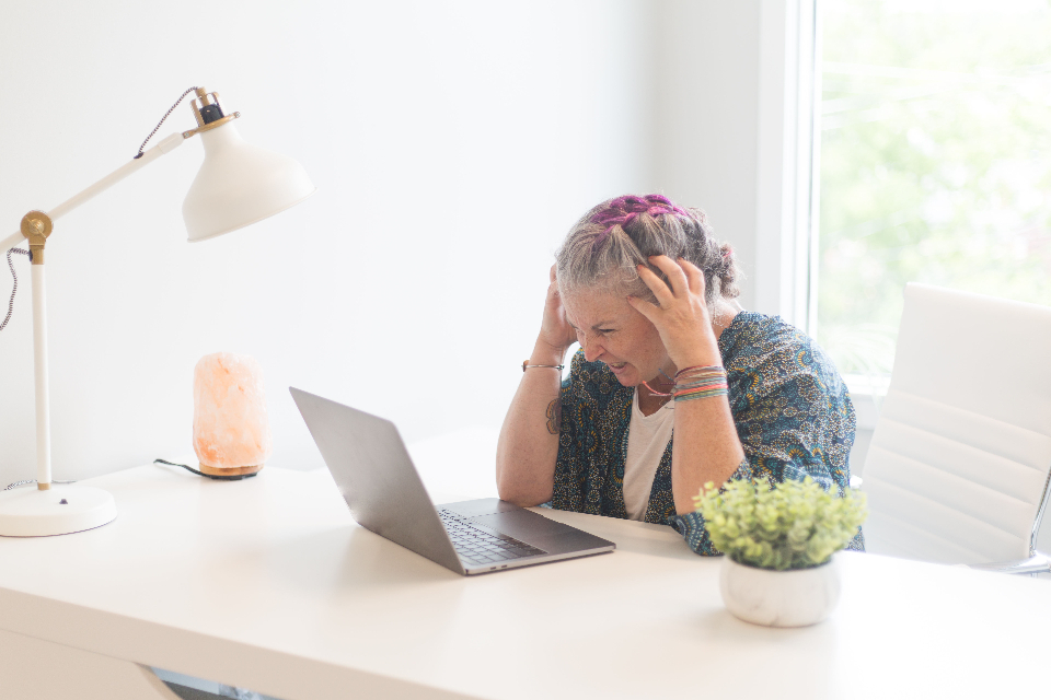 Stressed woman working at a laptop