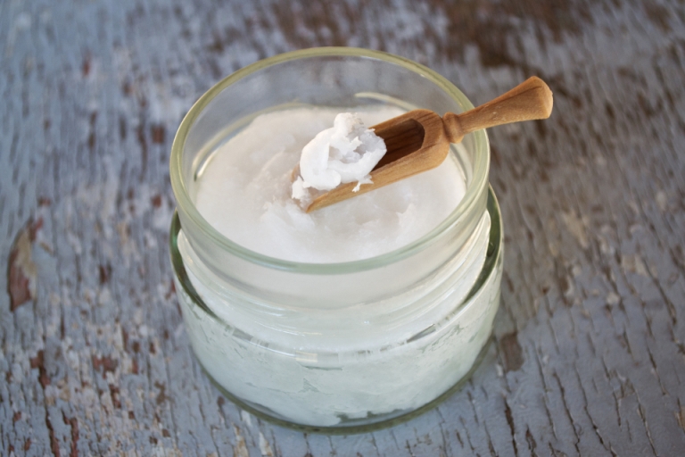 Jar of supplement powder with a wooden scoop