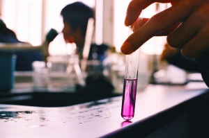 Pipette adding liquid to a test tube in a laboratory