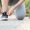 Runner tying a shoe before a morning run