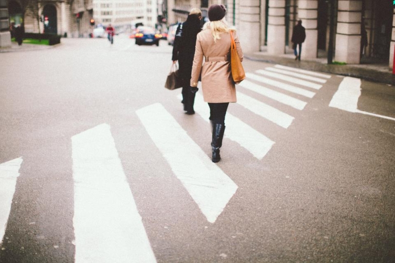 Person walking across a city crosswalk