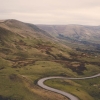 Winding road through green hills